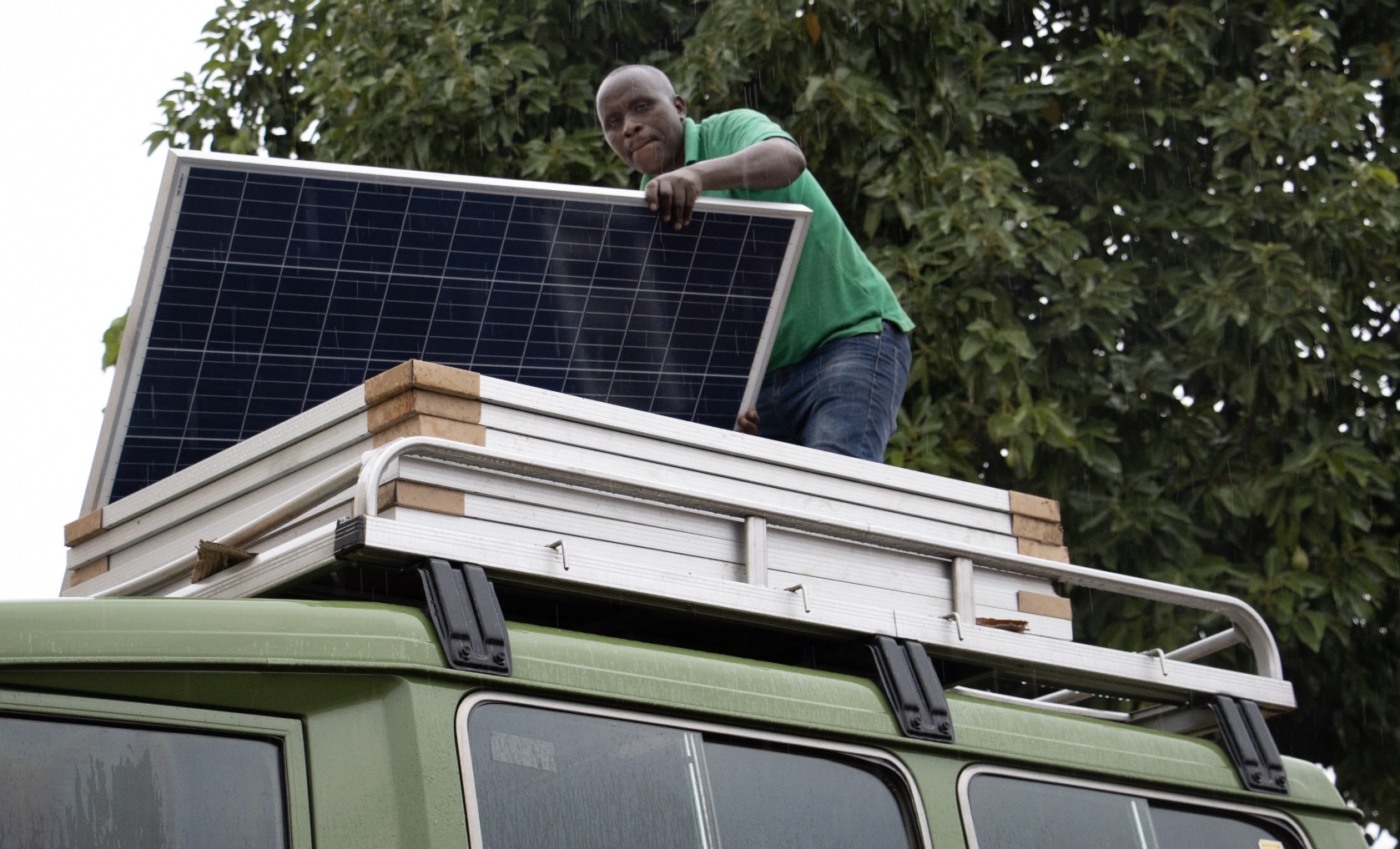 Solar panels being loaded onto the Green Machine roof